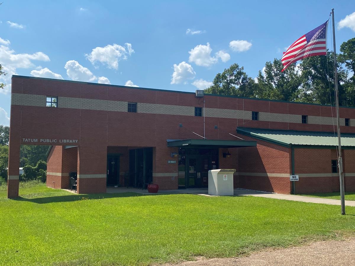 Front of Tatum Public Library building with flag raised.